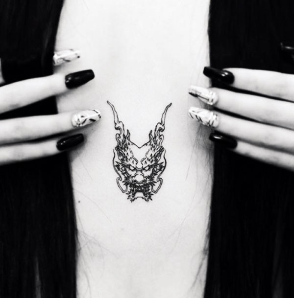smal dragon sternum tattoo